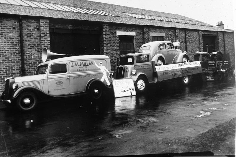 Vehicles parked at Millar's Garage, Callendar Rd, Falkirk, advertising